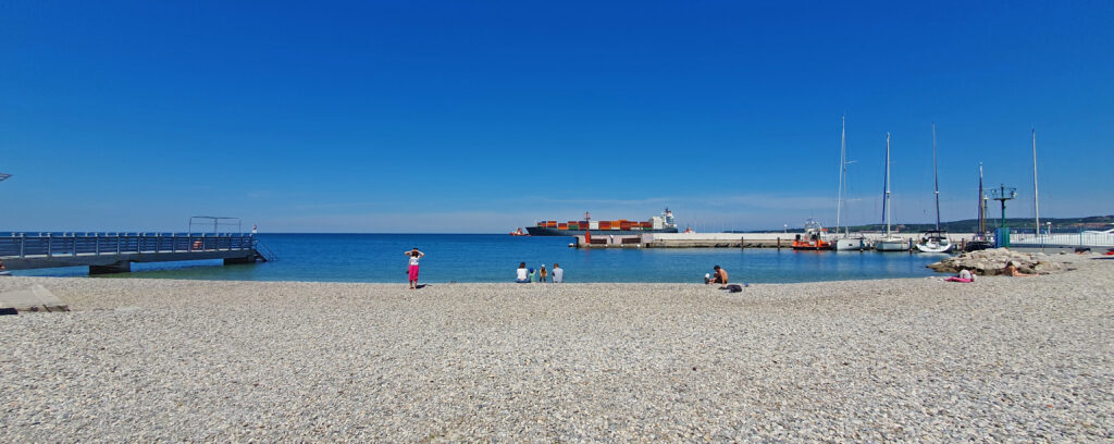New Žusterna Beach - Koper, covered with grass, trees for shade, beach bars, parking, water-sports