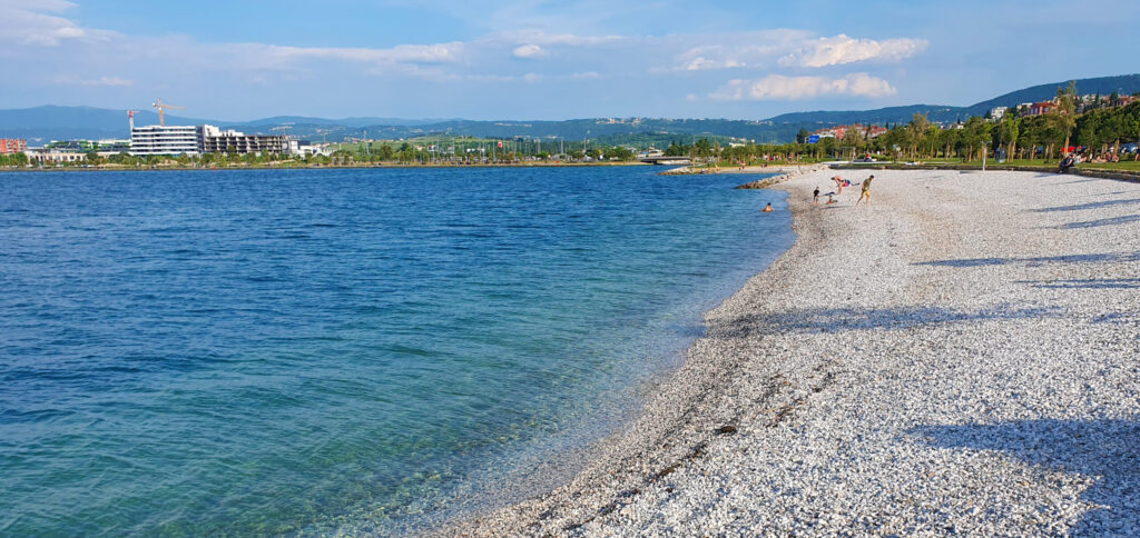 New Žusterna Beach - Koper, covered with grass, trees for shade, beach bars, parking, water-sports