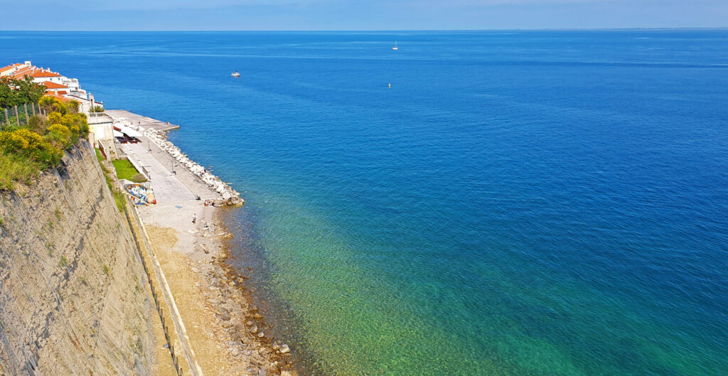 The beach under the church wall - Piran, Slovenian Beaches